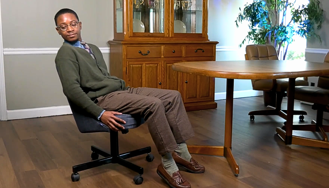 adult man checking the tilt of a Chromcraft swivel tilt dining chair