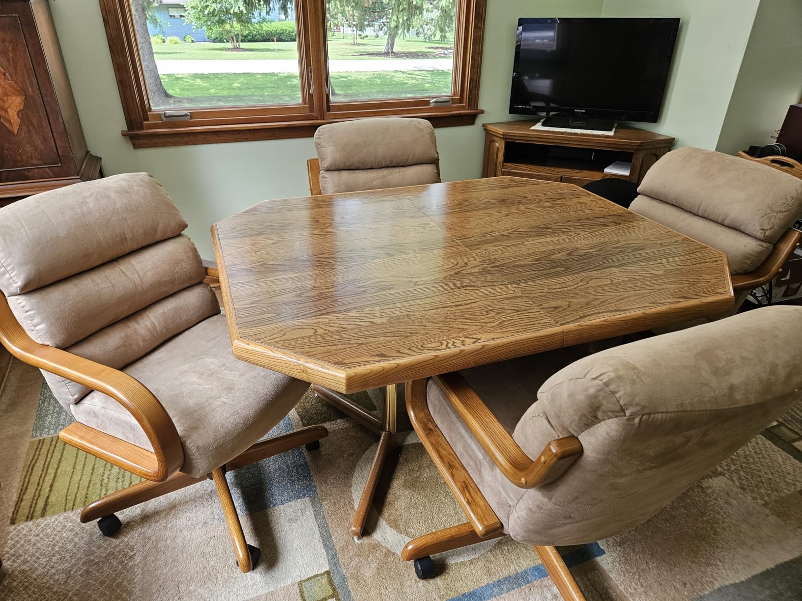 Wood dining table surrounded by four beige upholstered Chromcraft chairs in a customer home